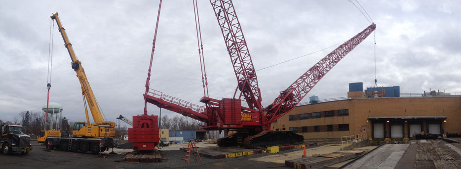 Red Crane Lifting a Load onto the Roof